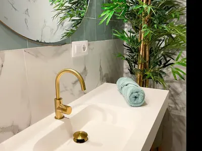 a bathroom sink with a faucet and a towel at Apartment Rafol in Vilanova i la Geltrú
