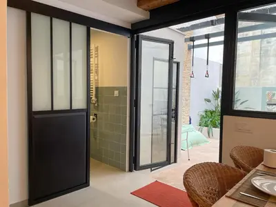 a black door in a room with a shower at Apartment Rafol in Vilanova i la Geltrú