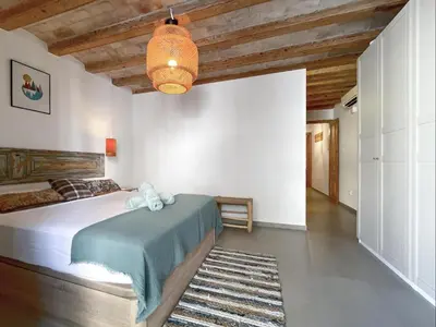 a bedroom with a bed and a chandelier at Apartment Rafol in Vilanova i la Geltrú