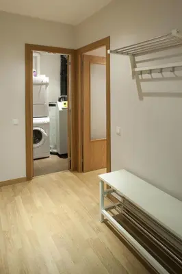 an empty room with a bed and a kitchen at Flateli Pelayo H1 in Barcelona