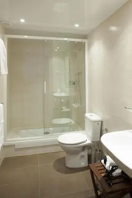 a bathroom with a shower and a toilet and a sink at Flateli Pelayo H1 in Barcelona