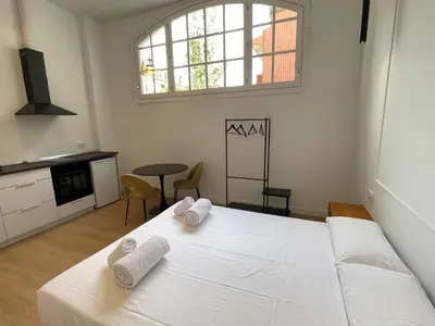 a bedroom with a white bed with towels on it at Hotelito Boutique Badalona Gran Villa in Badalona