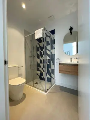 a bathroom with a shower and a toilet and a sink at Hotelito Boutique Badalona Gran Villa in Badalona