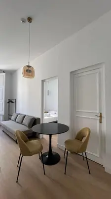 a room with a table and two chairs and a bed at Hotelito Boutique Badalona Gran Villa in Badalona