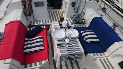 a table and chairs on a boat with a bottle of champagne at AMAZING FLAT IN CLASSIC SAILING BOAT in BARCELONA in Barcelona