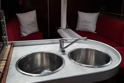 a silver sink in a bathroom with a mirror at AMAZING FLAT IN CLASSIC SAILING BOAT in BARCELONA in Barcelona