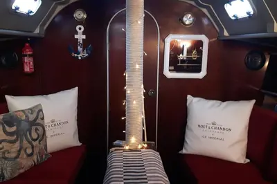 a room with pillows on a boat with at AMAZING FLAT IN CLASSIC SAILING BOAT in BARCELONA in Barcelona