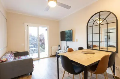a living room with a table and a couch at Besos Apartment Barcelona in Sant Adria de Besos
