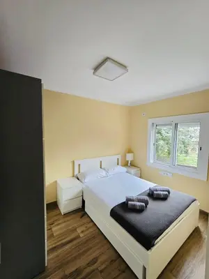 a bedroom with a bed with two towels on it at Besos Apartment Barcelona in Sant Adria de Besos