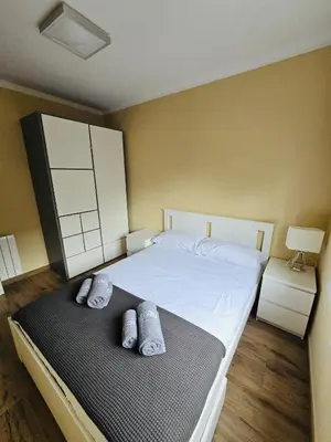 a bedroom with a large bed with two pillows on it at Besos Apartment Barcelona in Sant Adria de Besos