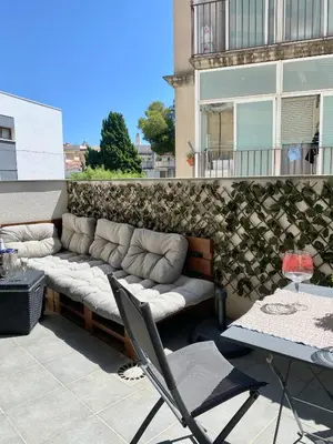 a couch sitting on the side of a building at Reina apartment in Sitges in Sitges