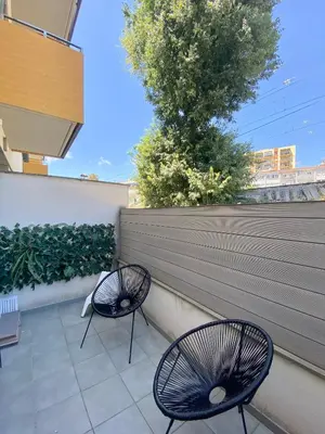 two chairs sitting on a patio with a fence at Reina apartment in Sitges in Sitges