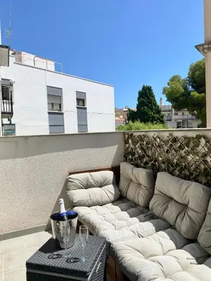 a couch sitting on top of a patio at Reina apartment in Sitges in Sitges