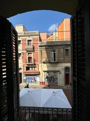 a bar on the beach with people standing around at Apartamento renovado con patio in Barcelona