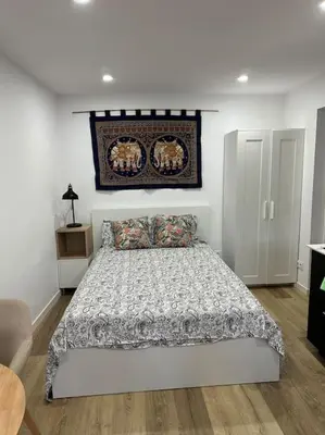 a bedroom with a bed with a comforter on it at Casa de Invitados in La Floresta Pearson