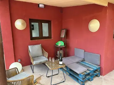 a red room with a couch and a table and chairs at Casa de Invitados in La Floresta Pearson