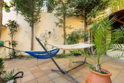 a hammock in a garden with a bike at Casa de Invitados in La Floresta Pearson