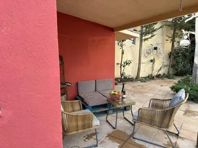 a patio with a couch and chairs and a table at Casa de Invitados in La Floresta Pearson