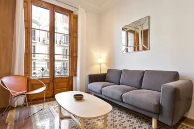 a living room with a couch and a table at Bailen Apartments by Central in Barcelona