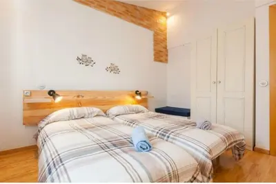 a bedroom with a bed with two towels on it at La Casita de Caldetes in Caldes d'Estrac
