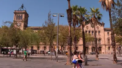 a large building with a clock tower and palm trees at Barcelona rent - Picasso House in Barcelona