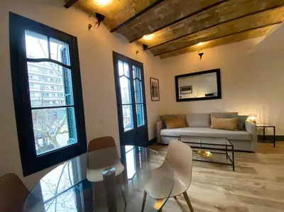 a living room with a glass table and a couch at Barcelona rent - Picasso House in Barcelona