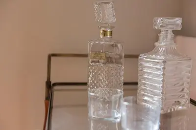 two glass bottles sitting on top of a glass table at Plaza Catalunya City Center Apartments in Barcelona