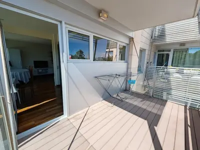 a hallway of a home with wooden floors and white walls at Bright 2 Bedroom Apartment with 2 Terraces Pool and Parking near Diagonal Mar Beach in Sant Adria de Besos