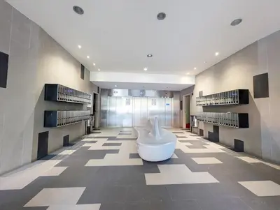 a row of metal elevator doors in a building at Bright 2 Bedroom Apartment with 2 Terraces Pool and Parking near Diagonal Mar Beach in Sant Adria de Besos