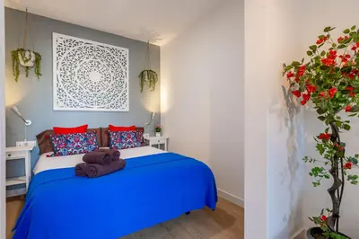 a bedroom with a blue bed with a teddy bear on it at Modern Apartment 2 rooms 15' Bcn Center - Fira Barcelona in Barcelona