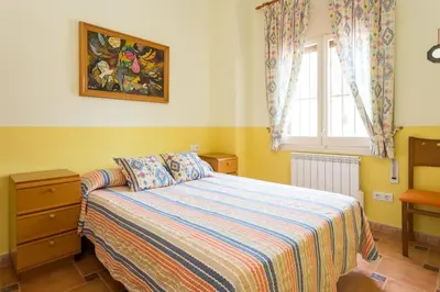 a bedroom with a bed and a window at Cal Vimón in Las Masucas