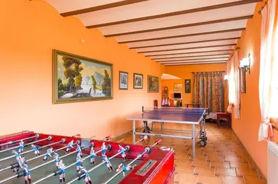 a room with a ping pong table in it at Cal Vimón in Las Masucas