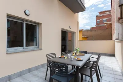 a patio with a table and chairs on a balcony at 4235 - AB Santa Coloma 3 B-I in Santa Coloma