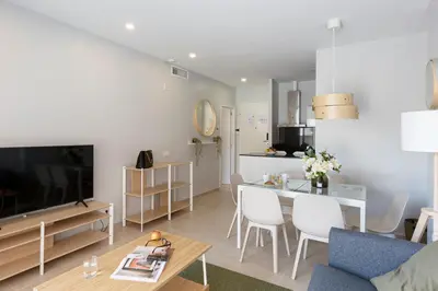 a living room with a couch and a dining room at 4235 - AB Santa Coloma 3 B-I in Santa Coloma