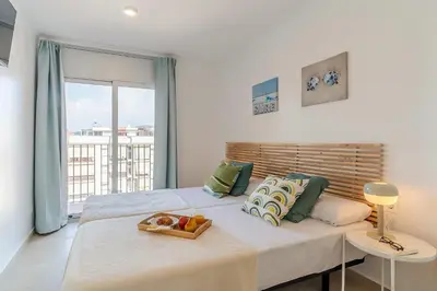 a bedroom with a bed with a tray of fruit on it at 4236 - AB Santa Coloma III in Santa Coloma