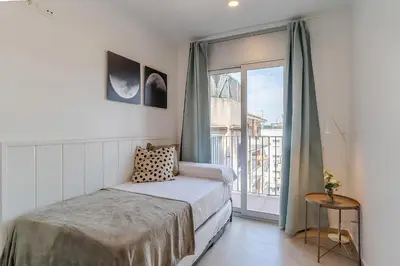 a bedroom with a bed and a large window at 4236 - AB Santa Coloma III in Santa Coloma