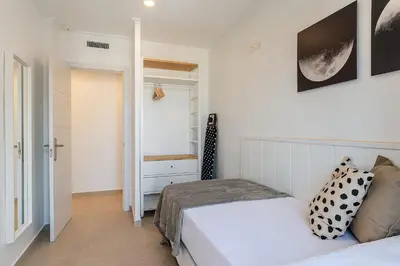 a small bedroom with a bed and a closet at 4236 - AB Santa Coloma III in Santa Coloma