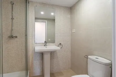 a bathroom with a sink and a toilet and a mirror at 4236 - AB Santa Coloma III in Santa Coloma