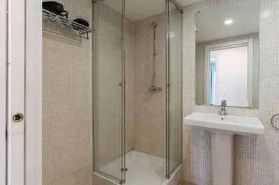 a bathroom with a glass shower and a sink at 4236 - AB Santa Coloma III in Santa Coloma