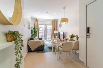 a dining room and living room with a table and chairs at 4237 - AB Santa Coloma III in Santa Coloma