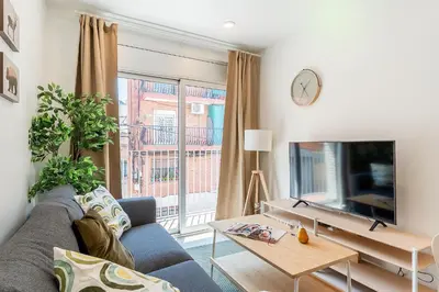 a living room with a couch and a tv at 4237 - AB Santa Coloma III in Santa Coloma