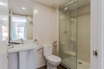 a bathroom with a toilet and a sink and a shower at 4237 - AB Santa Coloma III in Santa Coloma