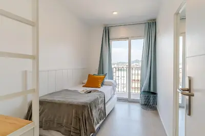 a small bedroom with a bed and a window at 4238 - AB Duplex Santa Coloma III in Santa Coloma