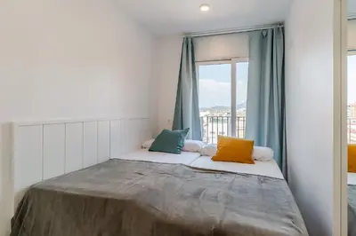 a bed with two pillows in a room with a window at 4238 - AB Duplex Santa Coloma III in Santa Coloma