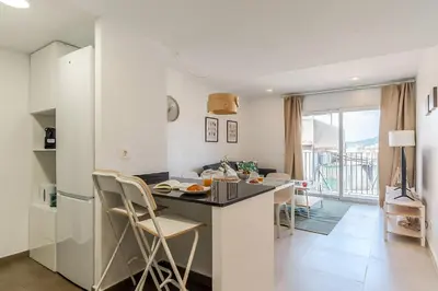 a kitchen and living room with a table and chairs at 4238 - AB Duplex Santa Coloma III in Santa Coloma