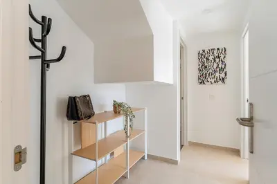 a hallway with white walls and a staircase with a shelf at 4239 - AB Duplex Santa Coloma III in Santa Coloma