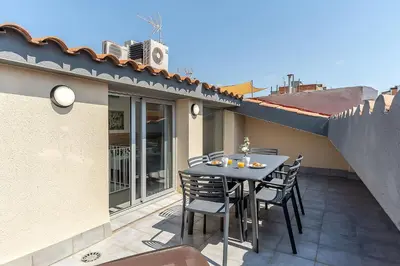 a patio with a table and chairs on a balcony at 4239 - AB Duplex Santa Coloma III in Santa Coloma