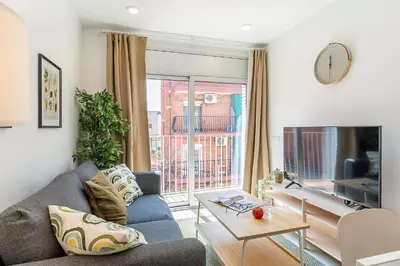 a living room with a couch and a tv at 4239 - AB Duplex Santa Coloma III in Santa Coloma