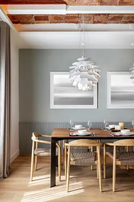 a dining room with a table and chairs and a chandelier at Luxury Apt with King Beds & Central AC in Heart of BCN in Barcelona