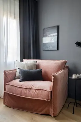 a brown couch sitting in a living room at Luxury Apt with King Beds & Central AC in Heart of BCN in Barcelona